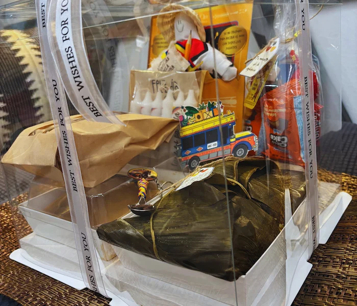 cajas o bolsas navideñas traen todo lo que nos hace sentir en casa: buñuelos recién hechos, natilla, tamales, masato, velitas, dulces típicos y hasta el Año Viejo para despedir el año con toda la alegría.